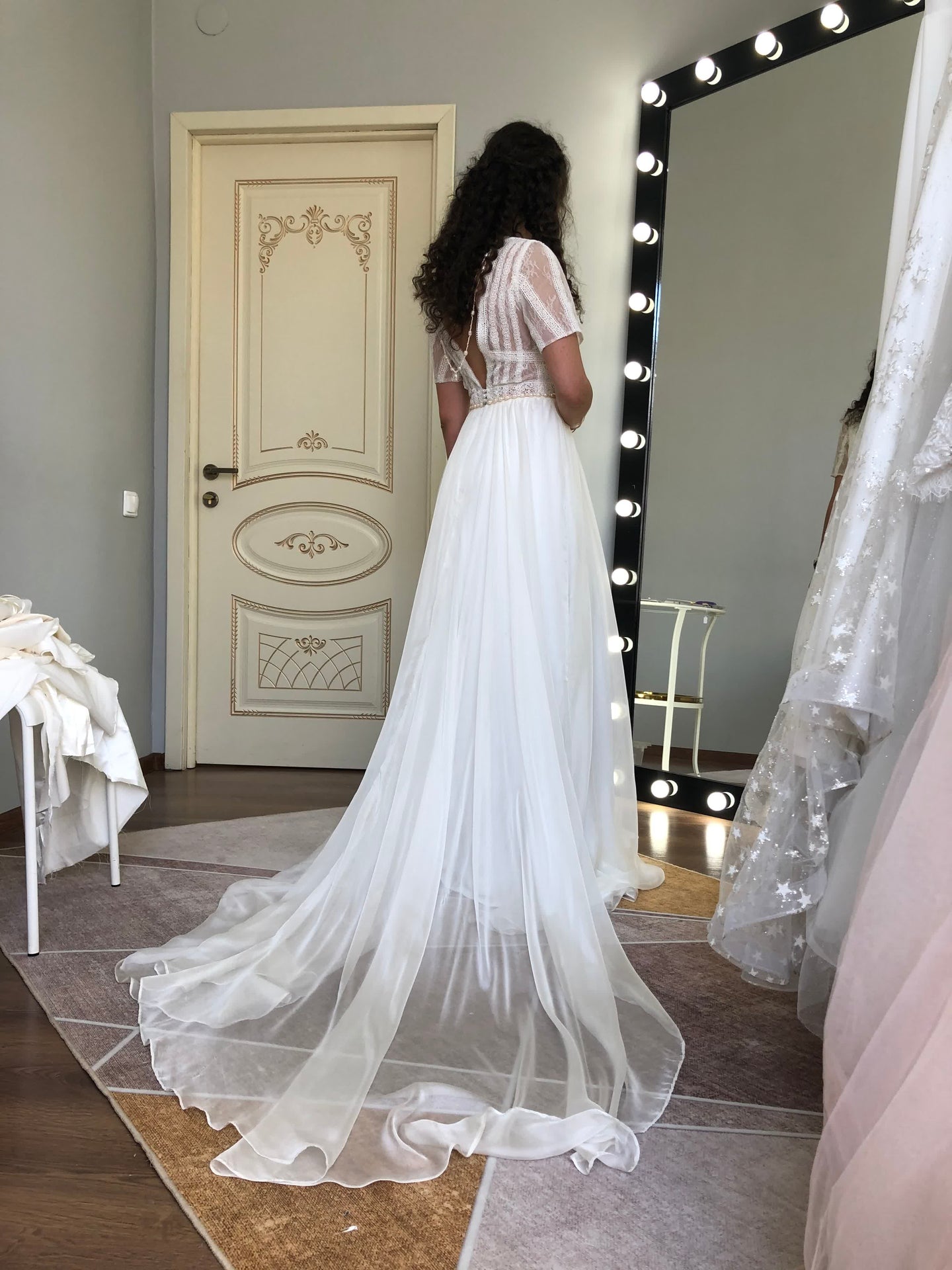 Bohemian custom wedding dress with illusion lace puff sleeves and flowing chiffon skirt, back view — a themed concept translated into a built gown