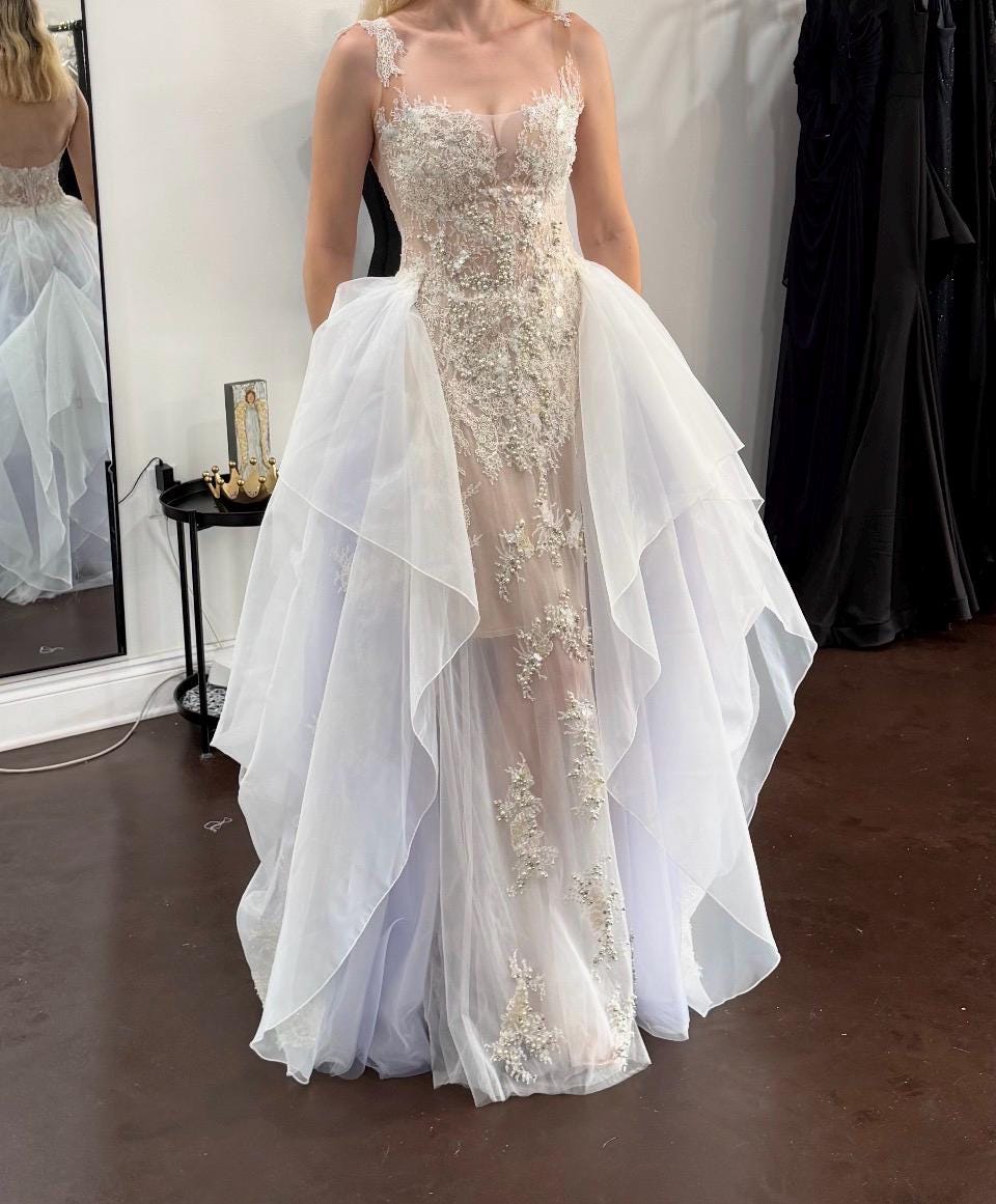 Hope wearing her completed custom Lutien Bridal wedding dress at her final fitting — sheer lace and pearl-embellished corset bodice with cascading tulle skirt