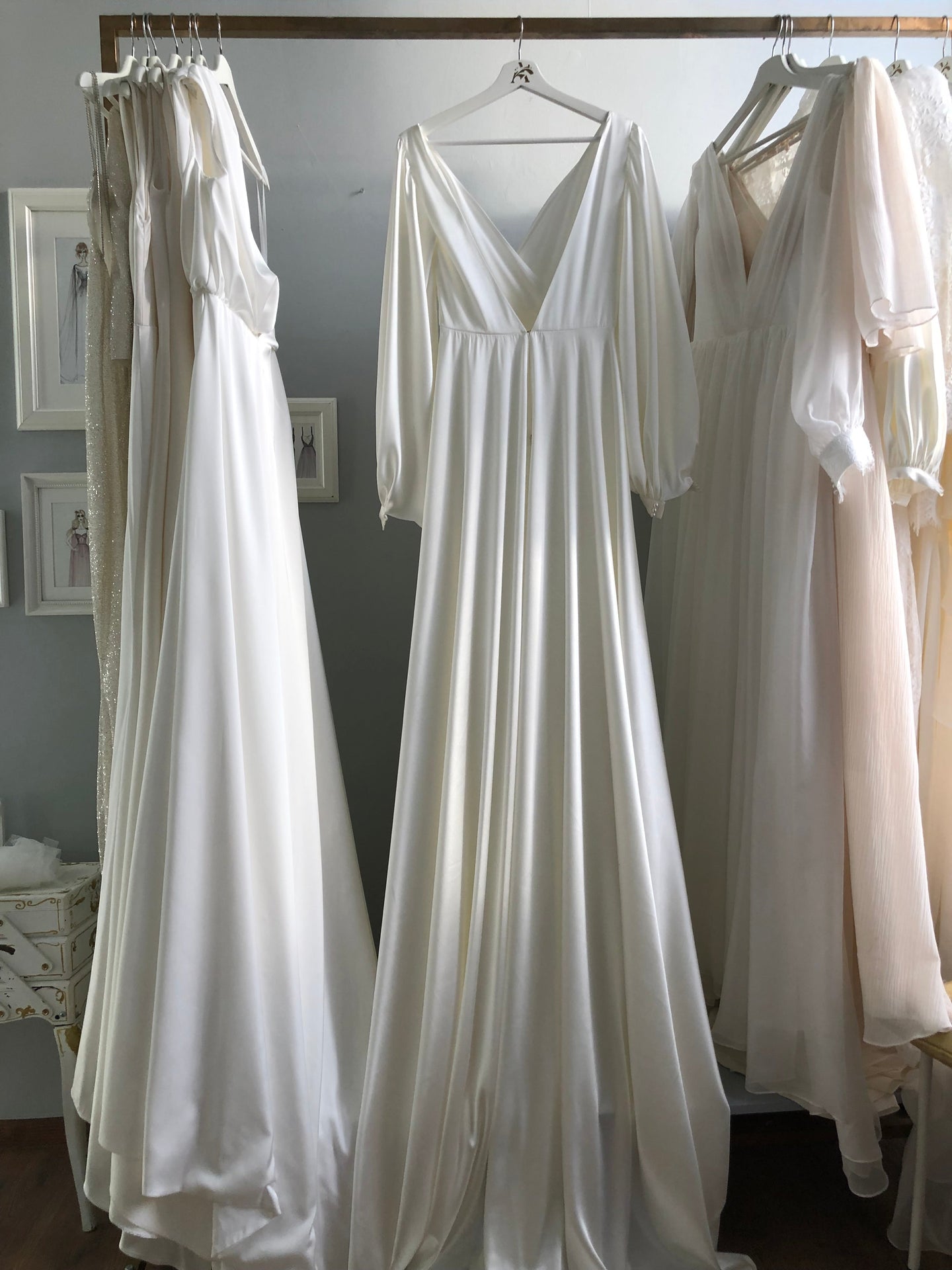 Satin V-neck column wedding dress with puff sleeves — the clean vertical line that Art Deco-inspired designs are built on