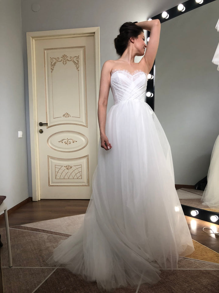 Strapless sweetheart tulle A-line wedding dress, 3/4 front view — custom bridal atelier gown with corset bodice