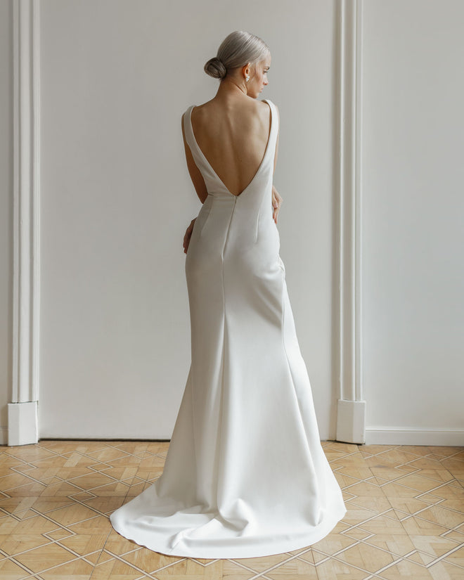Minimalist mermaid wedding dress with open back